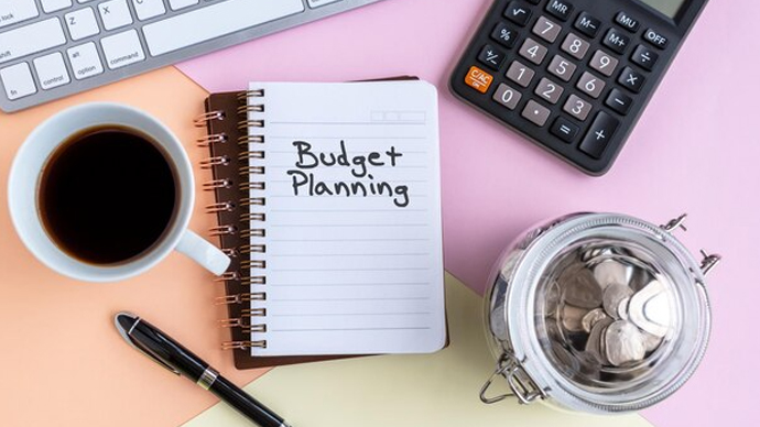 Simple monthly budget planning with notebook and calculator