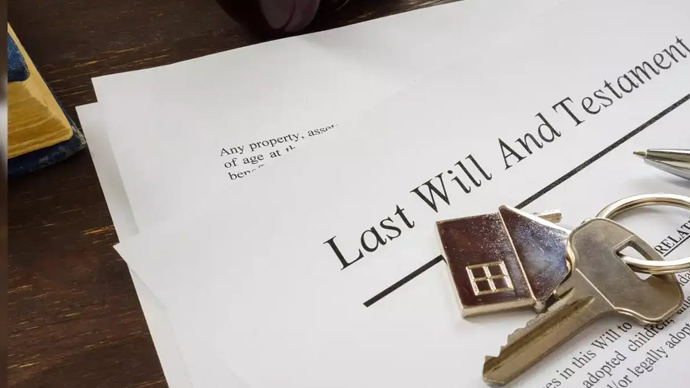 A lawyer helping a person draft a legal will to protect family assets